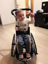 Alex Nicholas plays in his tiny wheelchair
