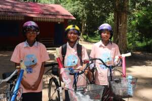 Sreynich with her bike (on the right)