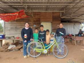 Srey Nit with her bike at home