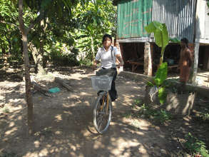 Soline next to her hut in Andong village