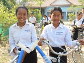 Sreyhang (left) with her new bicycle