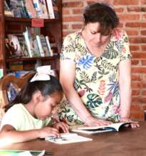 A teacher helping the children