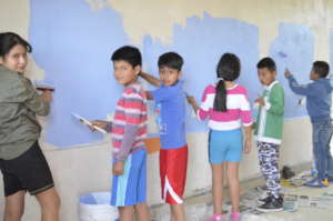 Children volunteered to paint new classroom.