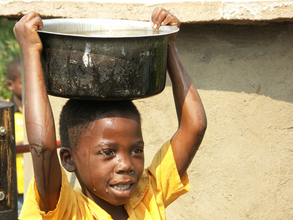 Young Boy with his bucket of clean drinking water