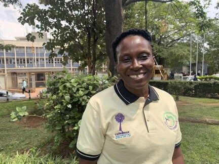 Clinical Lead Liz stands in front of Mulago