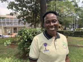 Clinical Lead Liz stands in front of Mulago