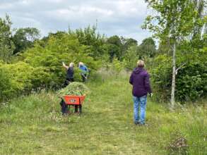 Volunteer team tackling spring hedge growth