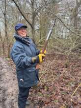 Cutting back branches to widen the path
