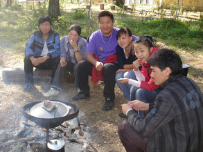 Throat-singer counselors around the cookfire