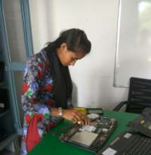 Indu working on repairing a laptop