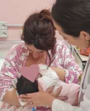 Esmeralda helping a new mom and her baby