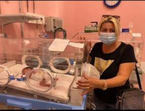 Donor Eva Keta visiting an orphaned baby she helps
