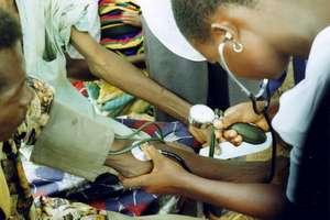 A health worker takes blood pressure
