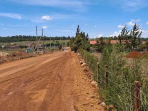 Road tarmacking ongoing next to the field