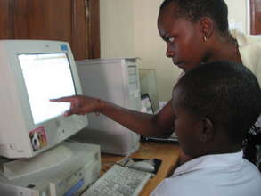 Student with instructor at AfricAid computer