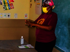 Nurse Domond instructs on COVID-19 hygiene.