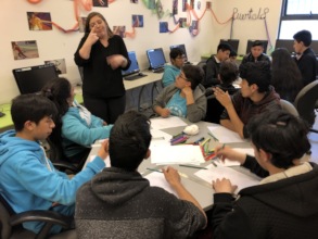 children working with the help of the interpreter