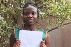 Kadiatu holding her Thank You letter