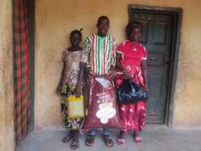 Mbalu with her parents receiving food support