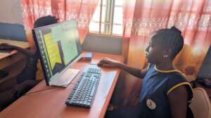 FAWE Student using new keyboard