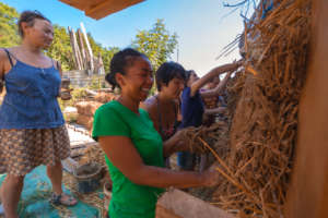 Volunteers applying clay during workshop