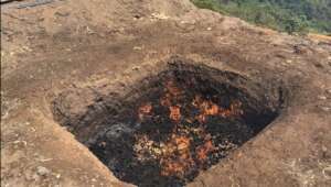 Pyrolyzing corncob in a trench