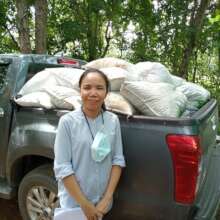 Farmer picking up biochar to use in soil