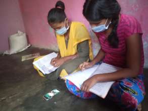 Girls using donated phones for online study