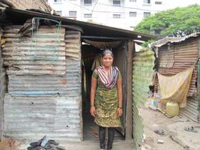 Renuka outside her house