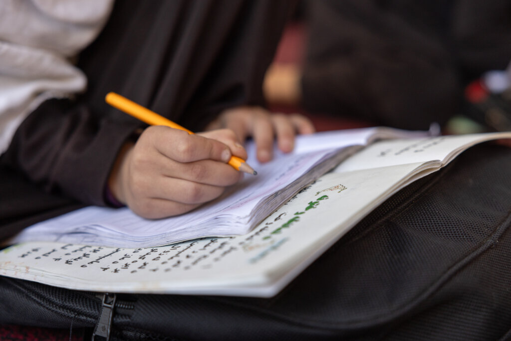 A girl taking notes in our CBE class - Bagrami