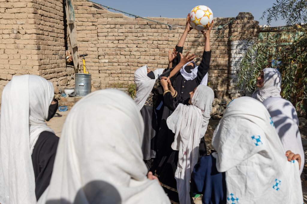 Girls playing outside one of our supported school