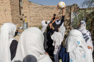 Girls playing outside one of our supported school
