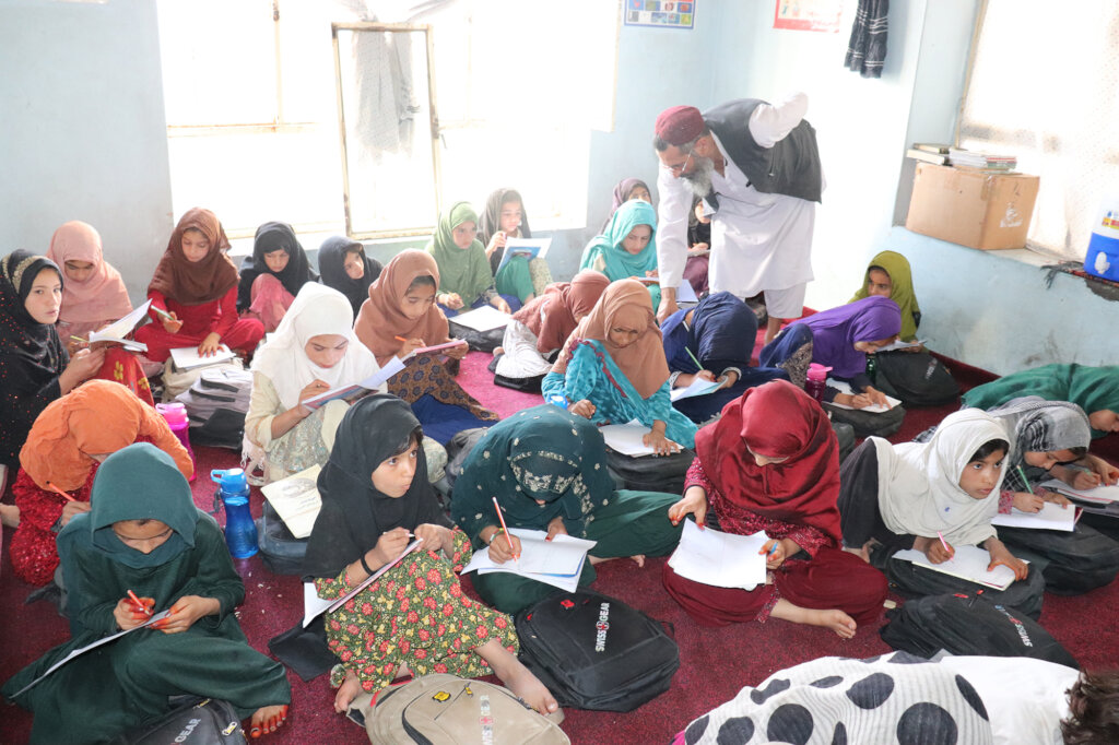 Girls learning together in a community classroom