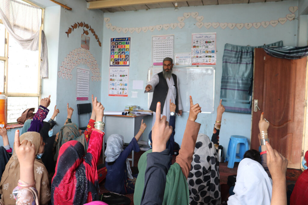 Girls eager to answer a question in class