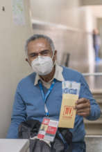 Vendor Jose Santillan receiving donation