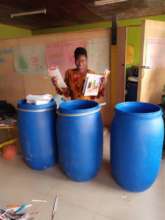 Collette with the drums of school supplies