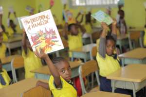 Kids in class displaying their new books
