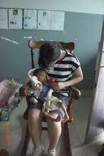 Seisen student comforts infant at City Orphanage