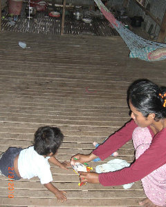 Mrs. San at home with Baby Lo Ji, age 16 months