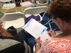 Woman reading the gathering agenda