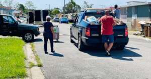 Giving supplies to people with flooded homes