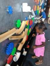Young visitor problem-solving on the magnet wall
