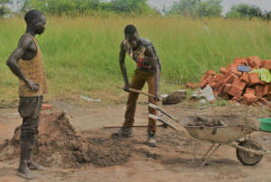 Parents help dig the new Abaka latrine pit