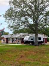 FEMA trailer in front of homes being worked on