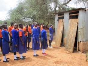 Students in East Africa line up to use latrines