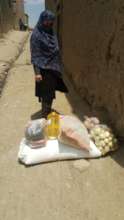 A student with 4 daughters receiving a food pack