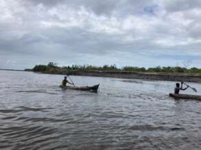 Switching to canoes to reach the isolated village