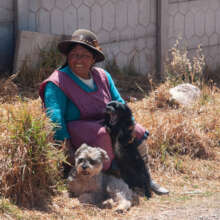 A owner of two dogs proudly smiling