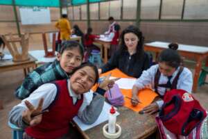 Elena supports students during a crafts session