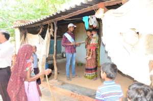 Volunteer going door to door to register children
